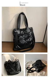 Detail of black quilted down tote bag with detachable strap and zipper pocket