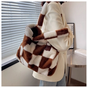 Detail of checkered faux fur tote bag with plush texture and stylish leather accents