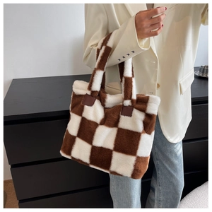 Detail of checkered plush tote bag with soft brown faux fur and leather handle accents