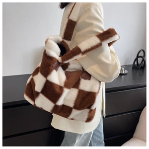 Detail of plush checkered tote bag with brown and white faux fur texture shown on shoulder