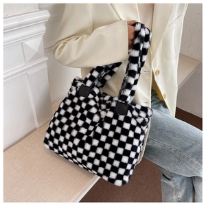 Detail of soft black and white checkerboard plush handbag with fuzzy texture