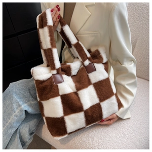 Detail of checkered plush tote bag featuring soft brown faux fur and leather handle accents