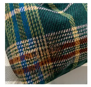 Close-up of multicolor checkered tweed tote bag featuring a red Fashion woven label