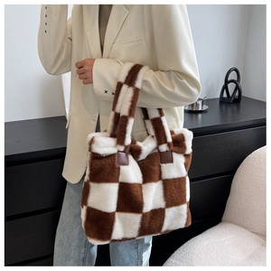 Close-up of plush checkerboard tote bag showing fuzzy texture and reinforced leather handles