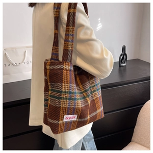 Detail of retro plaid tote bag with FASHION label and wide shoulder strap