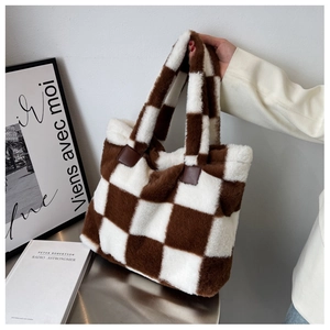 Close-up of fluffy checkerboard tote bag with soft brown plush and leather reinforcement