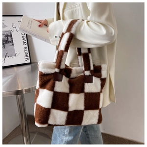 Detail of plush checkered tote bag with brown and beige faux fur texture for women