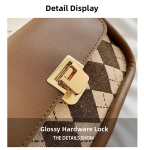 Macro detail of glossy golden rectangular metal clasp on retro checkered saddle bag