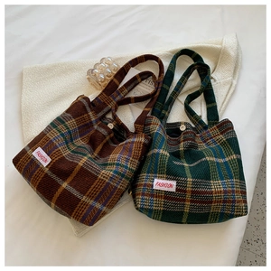 Close-up of retro plaid tweed tote bags with soft knit texture and fashion woven labels