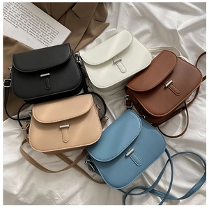 Multiple colors of vintage saddle crossbody bags with silver metal buckle detail