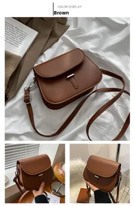 Close-up of brown saddle bag with silver buckle and adjustable shoulder strap