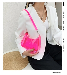 Neon pink transparent PVC shoulder bag featuring a sleek baguette shape and silver hardware