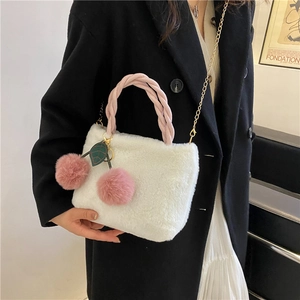 White plush cherry bucket bag with pink braided handle and gold chain strap for women