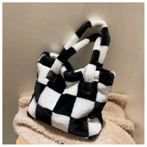 Close-up of black and white checkerboard plush laptop bag with soft faux fur texture