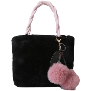 Plush black faux fur bucket bag with pink woven handle and cherry pom pom charm