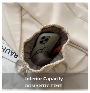 Interior view of straw bucket bag showing storage capacity for phone and cosmetics