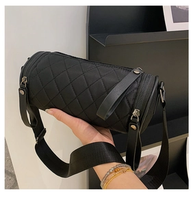 Close-up of quilted nylon bucket bag with adjustable wide strap and metal hardware