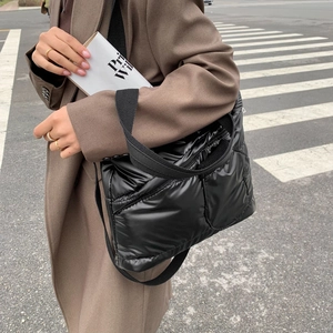 Quilted black down shoulder bag with glossy finish and spacious design for casual street style