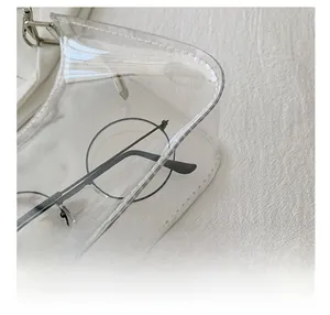 Detail showing high-quality stitching on a transparent PVC bag with a modern chain design