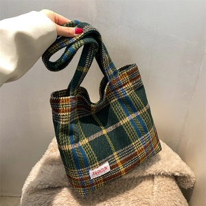 Plaid woolen tote bag in green and yellow checks featuring a fashion label on the front