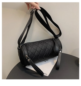Close-up of quilted black nylon cylinder bag featuring high-quality dual metal zippers