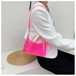 Neon pink transparent shoulder bag with chain strap shown on model for summer fashion