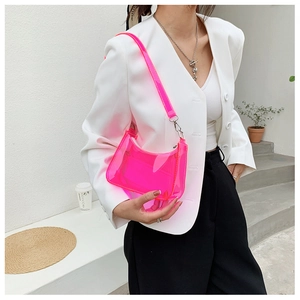 Neon pink transparent PVC shoulder bag styled with a white blazer on a female model