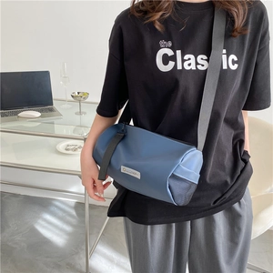 Morandi blue cylinder shoulder bag in durable nylon with athletic mesh side pocket