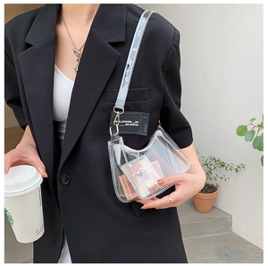 Detailed shot of transparent PVC half-moon crossbody bag with adjustable wide strap