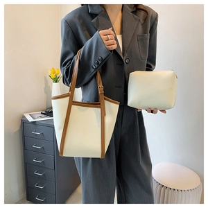 Detail of large cream tote bag with brown trim and matching inner pouch set for women