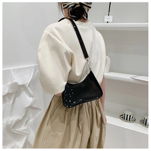 Sleek black glossy underarm bag with minimalist zipper and leather shoulder strap