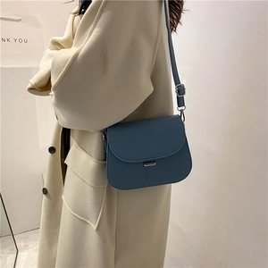 Minimalist Morandi blue saddle crossbody bag with metal clasp and adjustable strap