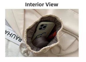 Interior view of straw woven bag holding a smartphone, powder compact and lipstick