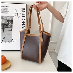 Detail of adjustable straps and contrasting stitching on the large PU leather tote bag