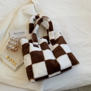 Brown and white checkerboard faux fur tote bag for women laptop on a soft white background