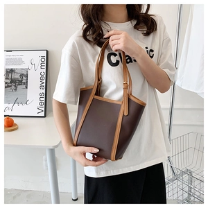 Close-up of contrast color tote bag with adjustable straps and spacious interior