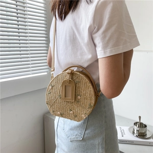 Straw round crossbody bag with floral embroidery and adjustable leather strap for women