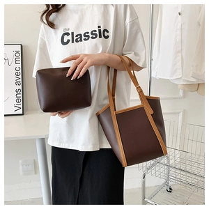 Detail of dark brown tote bag set including a matching zipper pouch and contrast edges
