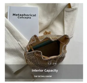 Internal capacity of the gold rhinestone bucket bag showing the lining and drawstring closure