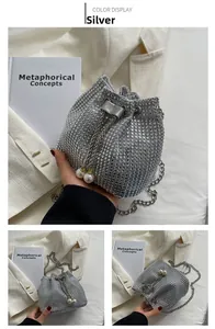 Detail of silver rhinestone bucket bag with drawstring pearls and shiny chain strap