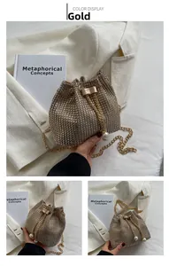 Detailed view of luxury gold rhinestone bucket bag with pearl drawstring and metal chain