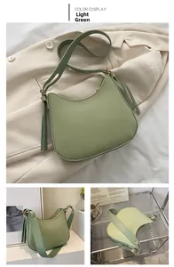 Three views of a light green crescent shoulder bag with smooth faux leather and gold hardware