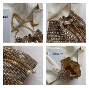 Detailed views of gold rhinestone bucket bag with pearl drawstring and metal chain