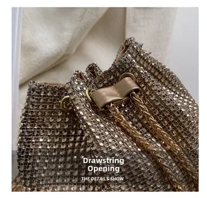 Detail of champagne gold rhinestone evening bag showing drawstring closure and luxury metal mesh