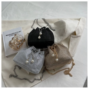 Chic rhinestone bucket bags in black, silver, and gold with pearl drawstrings and chain straps