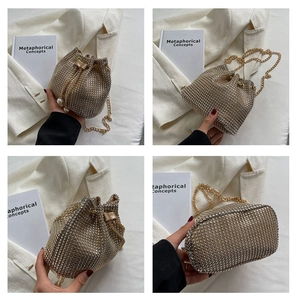 Detail of champagne gold rhinestone bucket bag with pearl drawstring and metal chain strap