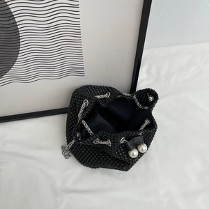 Sparkling black rhinestone bucket bag with silver chain strap and pearl accents