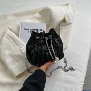 Sparkling black rhinestone bucket bag with silver chain and white pearl drawstring detail