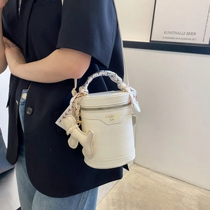 Fashionable creamy white crocodile texture bucket bag with silk scarf handle and dog charm