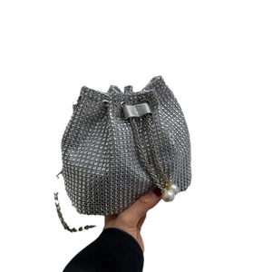 Sparkling silver rhinestone bucket bag with drawstring closure and pearl accents